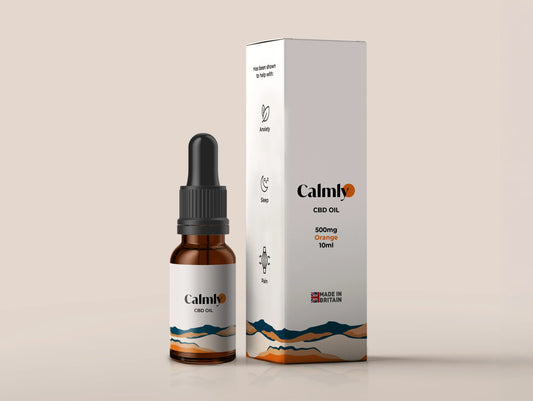 A bottle of Calmly UK-Grown Cold-Pressed Organic CBD Oil next to its packaging box.