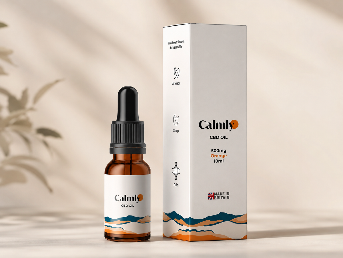 A bottle of Calmio CBD Oil next to its white packaging box, featuring a minimalist orange and blue mountain design on a warm beige background with soft leaf shadows.