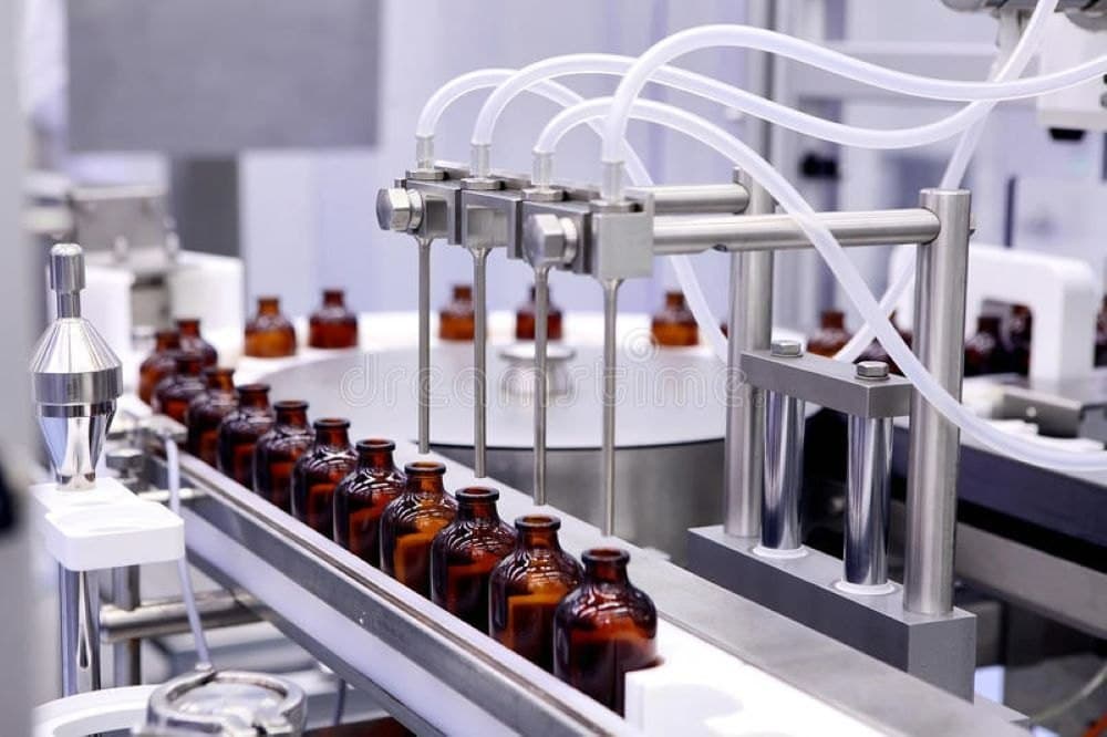 cbd oil bwing filled in bottles in cbd factory